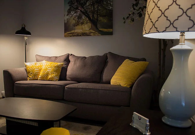 Comfortable counseling office with a couch and warm lighting